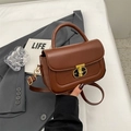 Brown retro flap crossbody bag with golden T-shaped lock and smooth leather texture - Brown