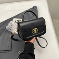 Chic black structured handbag with gold T-shaped lock and top handle for women - Black