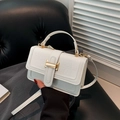 White minimalist crocodile embossed handbag with golden H buckle and round top handle - White