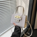 Chic cream white faux crocodile leather handbag with elegant gold wavy metal clasp - White
