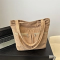 Brown corduroy tote bag with double front zippers in a minimalist office setting - Dark Brown