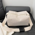 Creamy white corduroy crossbody pillow bag with wide adjustable shoulder strap and zipper - Off White