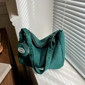 Dark green corduroy tote bag with small hanging pouch shown in minimalist interior light - Dark Green With Pendant