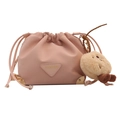 Pink drawstring bucket bag with a golden corner trim and a plush bear pendant charm - With Ornament / Pink