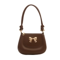 Chic dark brown faux leather handbag with a golden bow detail and slim top handle - Brown