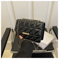 Detail of black quilted shoulder bag with gold chain strap and metallic lock closure - Black