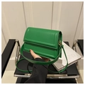 Detailed shot of bright green faux leather square crossbody bag with textured stitch lines - Green