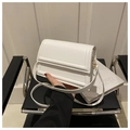 Close-up of a white leather crossbody bag with flap and quilted rectangle stitching - White