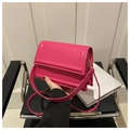 Detail of bright pink crossbody bag with gold metal hardware and detachable strap - Rose Pink