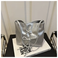 Detailed view of silver metallic bag featuring a textured finish and stylish bow knot detail - Silver