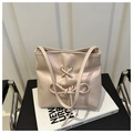 Detail of soft pink leather bucket bag with ribbon bow knot and metallic eyelets - Pink