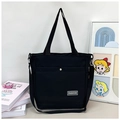 Detail der schwarzen Canvas-Tasche mit FASHION-Logo aus Metall und Tragegurt - Schwarz