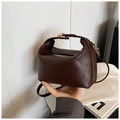 Detailed macro view of dark brown faux leather bag with rich rabbit embossed pattern - Brown