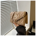 Detail of beige quilted shoulder bag with gold chain strap and decorative tassel - Khaki