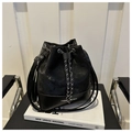 Detail of black drawstring bucket bag with chain closure and white FASHION BAG text - Black