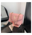 Detailed view of pink quilted chain bag featuring a gold S logo and tassel accent - Pink