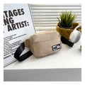 Detail of beige nylon crossbody bag with fashion label and adjustable black strap - Khaki