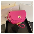 Detail of hot pink saddle bag featuring a square gold geometric clasp and leather texture - Pink