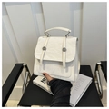 Detail of cream pleated leather handbag featuring decorative straps and metal buckles - With Pendant / White