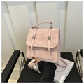 Detail view of pink pleated PU leather backpack with decorative metal buckles and top handle - Pink