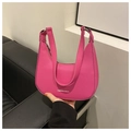 Detailed shot of pink faux leather underarm bag with lychee texture and metal rings - Rose Pink