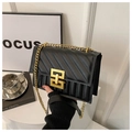 Black quilted crossbody bag with gold chain and geometric clasp in luxury vintage style - Black