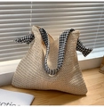 Detail of V-shaped straw weave texture and houndstooth fabric strap on beige tote - Off White