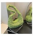 Detail of light green popcorn textured crescent bag showing pleated fabric and elastic design - Green