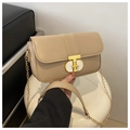 Close-up of beige leather shoulder bag with a gold T-lock and chain strap detail - Khaki