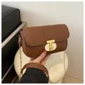 Detail of classic brown PU leather handbag featuring a gold T-shaped metal twist lock - Brown