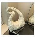 Detail shot of white popcorn texture fabric on a stylish crescent shoulder bag - White