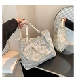 Detailed close-up of large tote bag with wave prints and pearl chain decoration - White