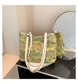 Macro detail of tote bag showing traditional landscape tapestry texture and pearl charm - Green