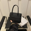 Mini black pebbled leather crossbody bag with top handle and gold chain strap - Black
