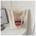Close-up of stylish canvas tote bag with red lips and pink LOVE print detail - White