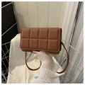 Quilted caramel brown crossbody bag with padded square pattern and slim shoulder strap - Brown