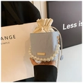 Detail of light blue pleated bucket bag featuring pearl handle and gold chain strap - Blue