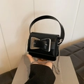Mini black handbag featuring a large silver bow buckle and elegant metal chain strap - Black