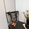 Translucent smoky grey PVC tote bag featuring black butterfly print and ribbon handles - Black