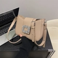 Elegant apricot shoulder bag with a sparkling rhinestone buckle in an office setting - Khaki