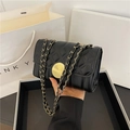 Chic black quilted mini crossbody bag with golden chain strap and round metal clasp - Black