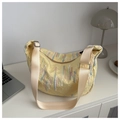 Detail of yellow crescent tote bag featuring embroidered wavy textures and wide strap - Yellow