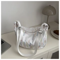 Detail showing white pleated nylon bag texture with colorful rainbow embroidery lines - White