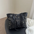 Black tote bag with golden butterfly embroidery, featuring metal studs and long straps - Solid Black