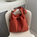 Minimalist orange nylon bucket bag with drawstring closure and spacious design - Orange