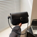Chic black faux leather shoulder bag with gold oval buckle and knotted strap details - Black