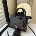 Matte black woven tote bag with silk bow decoration and golden metallic accents - Black