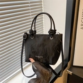 Chic black pleated leather bucket bag with knotted handles and adjustable shoulder strap - Black