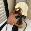 Brown woven tote bag with a black bow and crossbody strap for stylish commute use - Yellow Brown