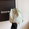 Mint green drawstring bucket bag with silver butterfly buckle shown in hand - Butterfly Buckle Pearl Drawstring Style / Green